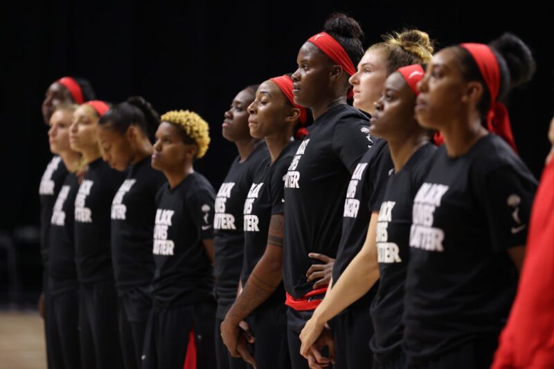 Photoof WNBA Atlanta Dream standing in solidarity wearing Black Lives Matter shirts